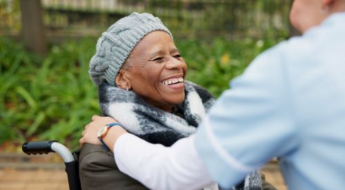 Nurse, smile and park with old woman in a wheelchair for retirement, elderly care and physical ther